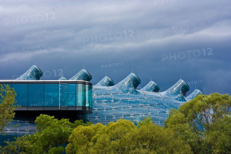 Kunsthaus Graz, a huge bluish bubble called "friendly alien" is the art gallery from Graz, Styria, Austria. Dark clouds before r