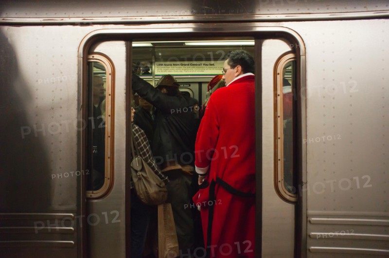 Christmas revelers participating in the annual Santacon travel on the subway in New York on Saturday, December 10, 2011. Santacon, primarily a pub crawl in Santa and other Christmas related costumes, attracts hundreds of masqueraders going from bar to bar. The drinkers were encouraged to imbibe at e