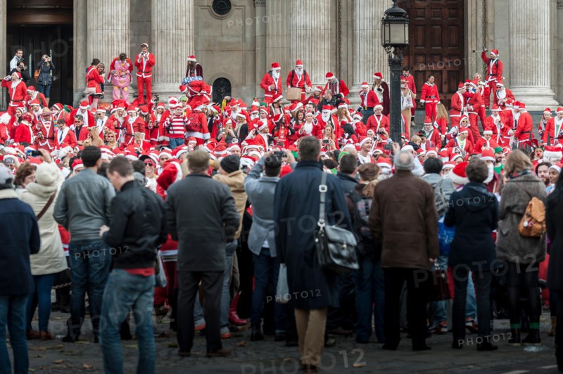 London, UK. 14th December, 2013.  Hundreds of Santas gathering on the steps of St Pauls Cathedral before they march off to meet up with groups of other Santas to celebrate the annual Santacon.  Photographer: Gordon Scammell/Alamy Live News