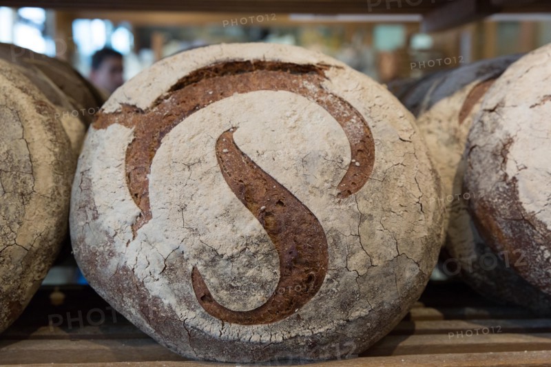 The registered trademarked "P" on a round sourdough country bread referred to as a miche or pain Poilâne in Paris France