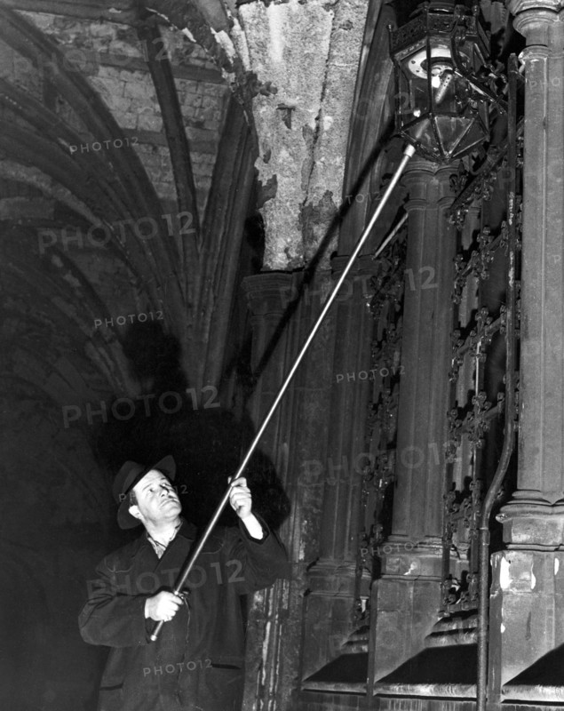 The lamplighter, Mr G Allwn who is employed by the Gas, Light and Coke company and has put on the lights in the Temple for the past 28 years Circa 1950