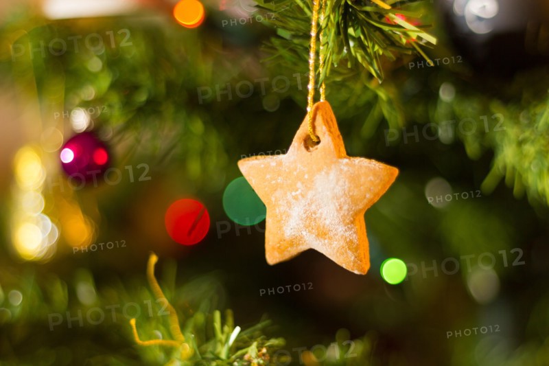 A home-baked gingerbread decoration on a Christmas tree.