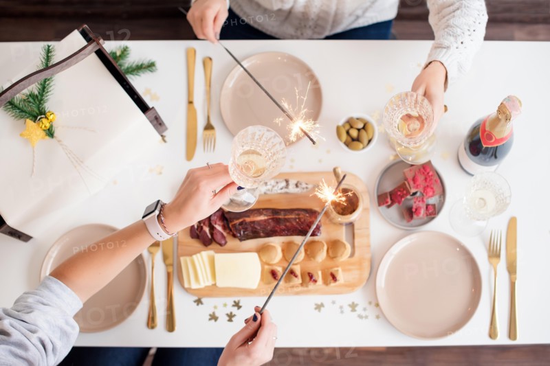 Christmas Family Dinner Table Concept. Christmas feast. Holiday Gold place setting, overhead shoot