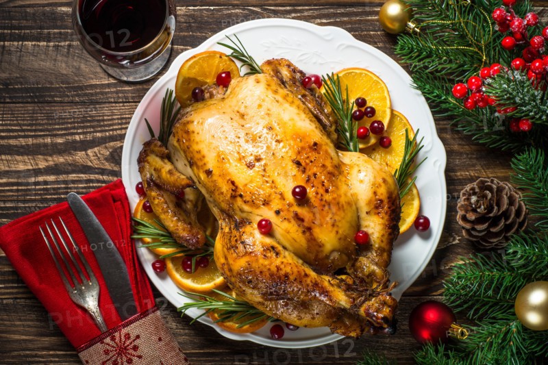 Chrismas chicken baked with cranberry, orange and rosemary. Christmas dinner.