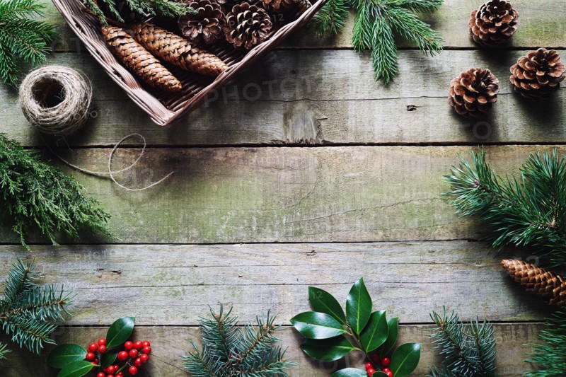 Christmas decoration using fresh and all natural materials on wooden table.