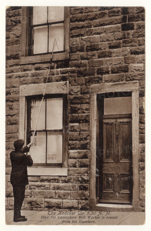 Early 1900's postcard of Knocker Up man, known as the Knocker upper, (before alarm clocks) in Accrington, Lancashire, England, U.K. posted September 1918. The Knocker Upper woke up the mill workers in mill towns.
