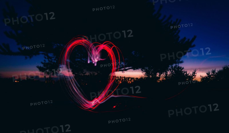 Passionate token of love as a surreal, stylish and cool heart-shaped fire ring outdoors at night. pleasure and passion.