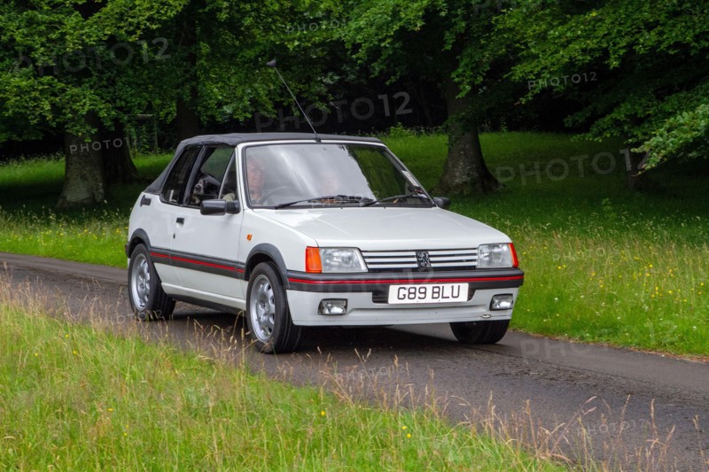 A 1990 90s white Peugeot 205 Cti Cabriolet Petrol at ‘The Cars the Star Show” in Holker Hall & Gardens, Grange-over-Sands, UK