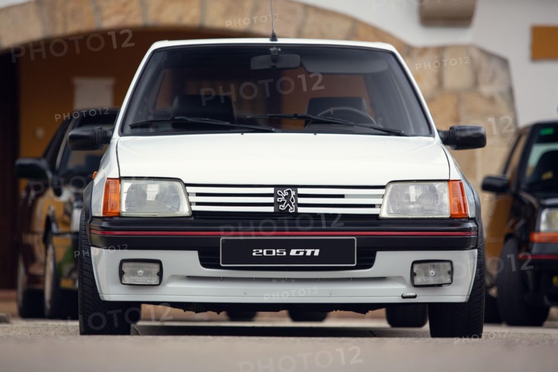 Reocin, Cantabria, Spain - October 2, 2021:  Car show in Reocin. Original white Peugeot 205 GTI. The Peugeot 205 is a car produced by the French manuf