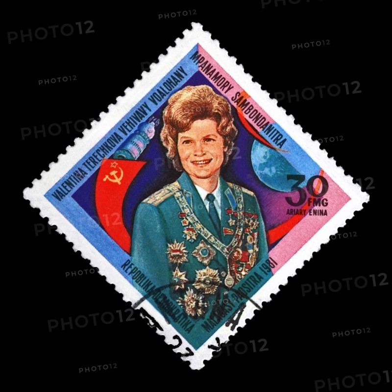 Valentina Tereshkova, soviet astronaut, 1st woman in the space, red soviet flag, circa 1981. canceled postal stamp printed in Madagascar isolated on