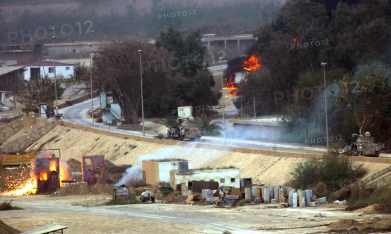 Iraq War April 2003 The opening shots in The Battle for the Republican Palace fall short into the grounds of the Palace in Baghdad Our Picture Shows American armoured vehicles firing on Iraqi positions