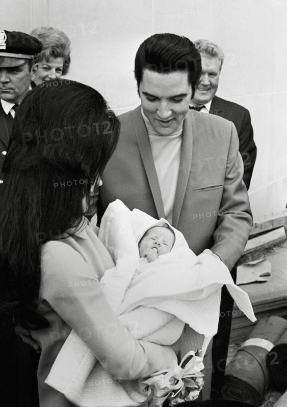Elvis Presley, Priscilla Presley,  leaving the Baptist Hospital, Memphis, Tennessee, with their daughter Lisa-Marie, born at the hospital on February 1, 1968.  File Reference # 33635_680CPC