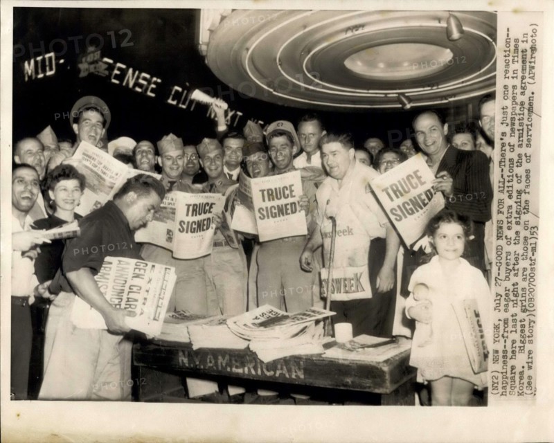 Jul. 27, 1953 - News For All: There's just one reaction: happiness from eager buyers of extra editions of newspapers in Times square her last night after the signing of the armistice agreement in Korea. Biggest grins are those on the faces of servicemen.