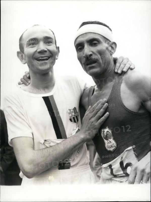 Jun. 26, 1966 - Alain Mimoun, who won the 10,000 M race in Paris a week ago, surprised us again by winning the Marathon in front of Combes at 46 years-old. Picture: After his victory, Combes congratulates Mimoun.