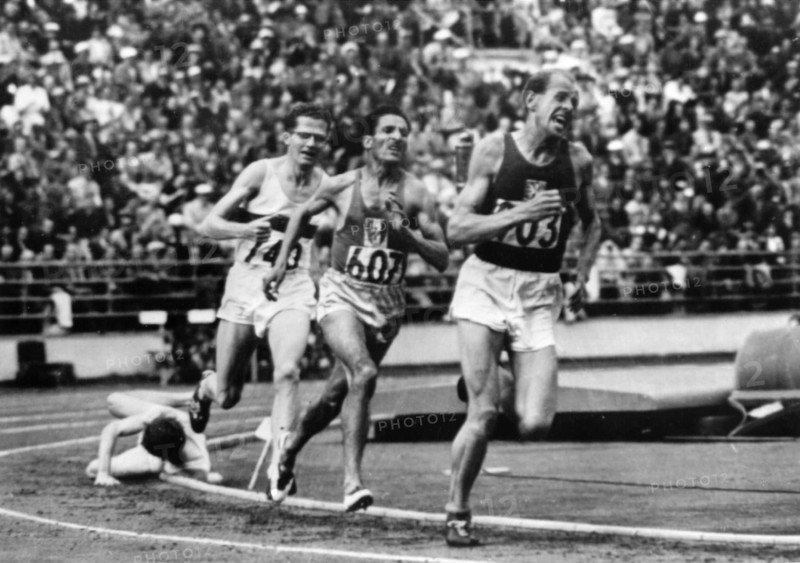 Finland 1952 Olympics, Emil Zatopek (CZE), from right, followed by Alain Mimoun (FRA), Herbert Schade and Chris Chataway, competes in 5.000 m race at Helsinki.