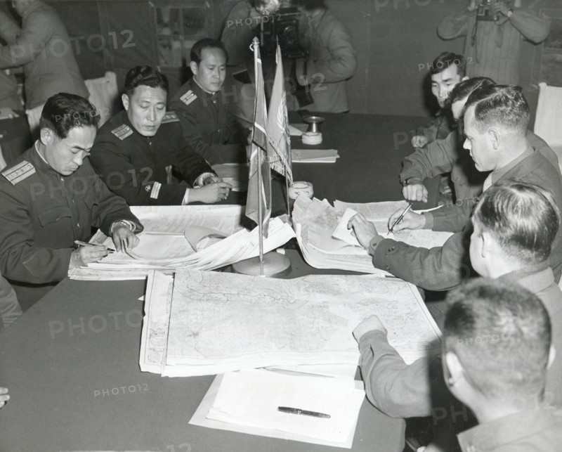 Panmunjom, Korea - Col. James C. Murray, Jr., USMC (rt) and Col Chang Chun San, of the North Korean Communist Army (left) initial maps showing the North and South boundaries of the Demarcation Zone, during cease fire talks.