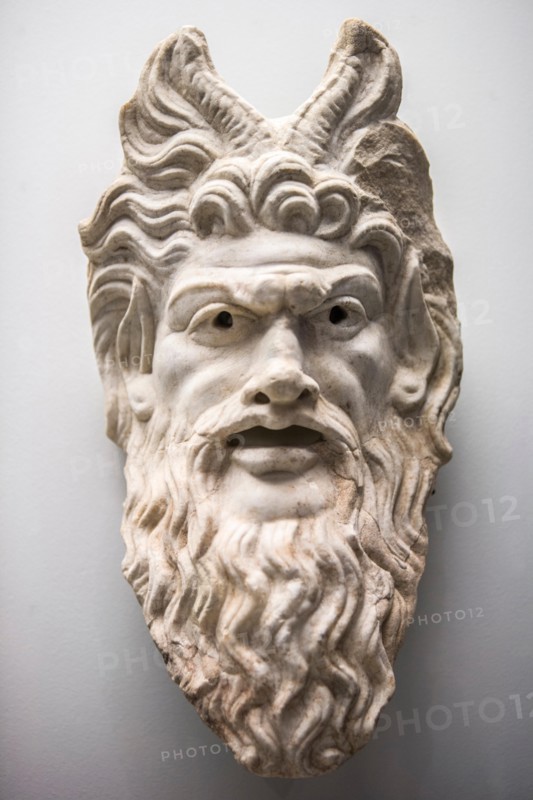 Cordoba, Spain - June 4, 2011: Mask of the God Pan. Representation in marble of the form of a theatre mask. Archeological Museum of Cordoba, Andalusia