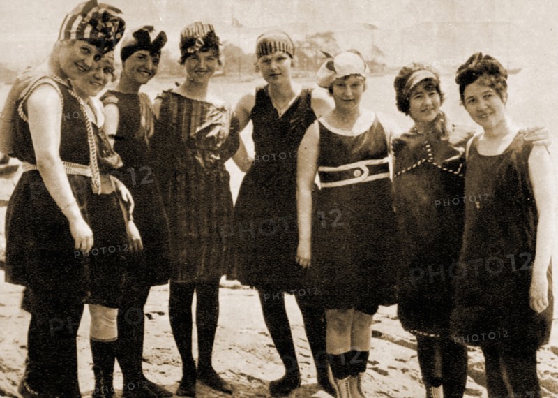 A circa 1910 photograph of a group of young ladies in Britain modelling fashionable swimwear of the time