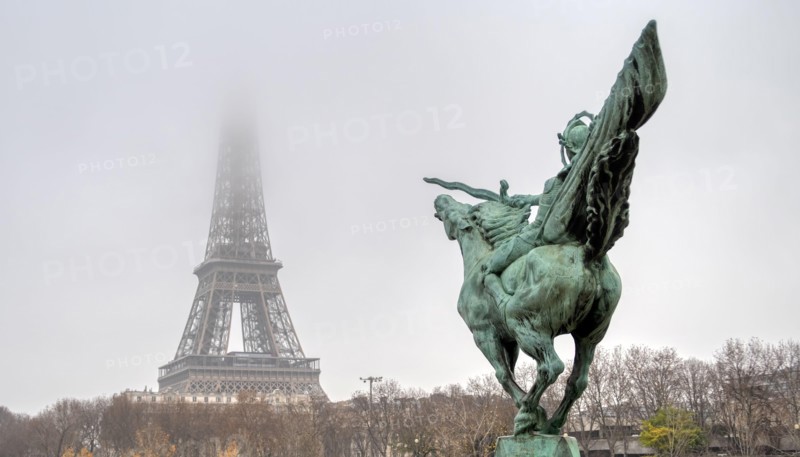 Eiffel Tower and Bir-hakeim statue on a misty day