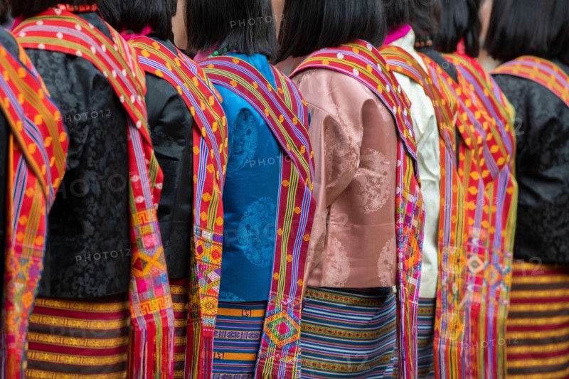 Bhutan, Punakha Dzong. Punakha Drubchen Festival, female dancers in traditional colorful attire.
