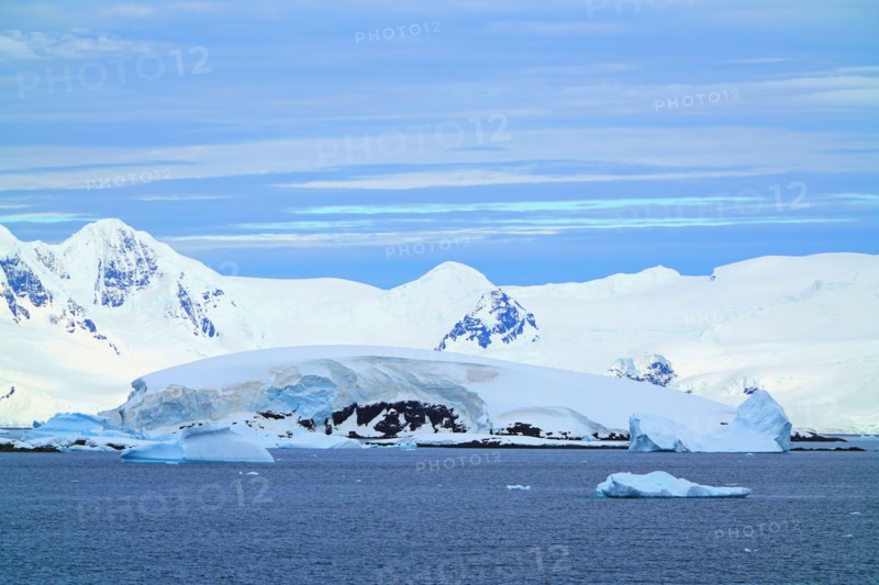 Various types of iceberg landscapes. There are ice floes, glaciers, oceans, radioactive clouds, sunshine, this is the Antarctic summer.