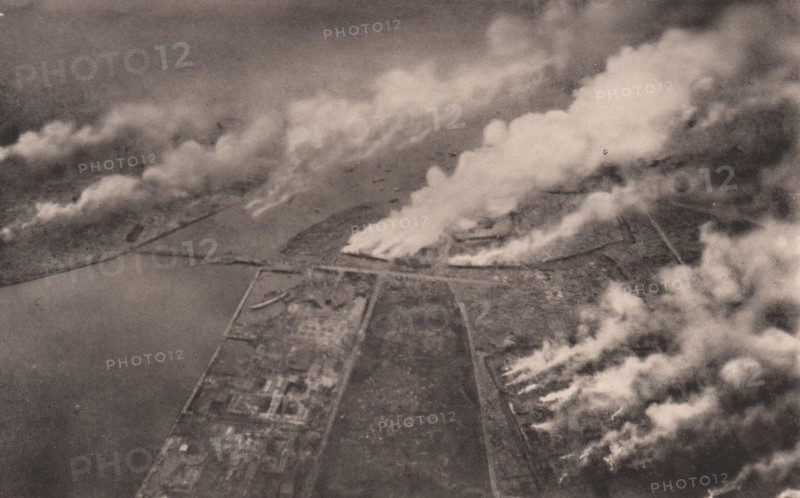 Japan Earthquake 1923: Tokyo ablaze : a horrible scene on the banks of the sumida river, as snapshot from on board a military aeroplane