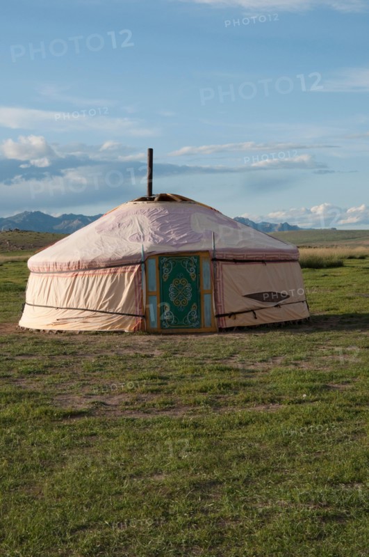 Mongolian traditional house named ger or yurt, in a beautiful landscape. Blue sky. Rural area near Kharakhorum, Mongolia. These houses are now used to