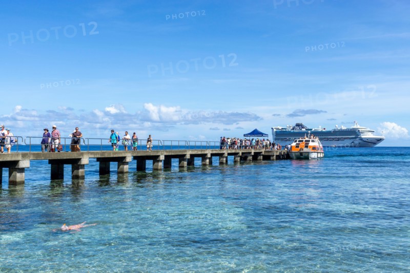 Passengers being transferred to jetty by small tenders from cruise liner anchored off Kiriwina Island, Papua New Guinea