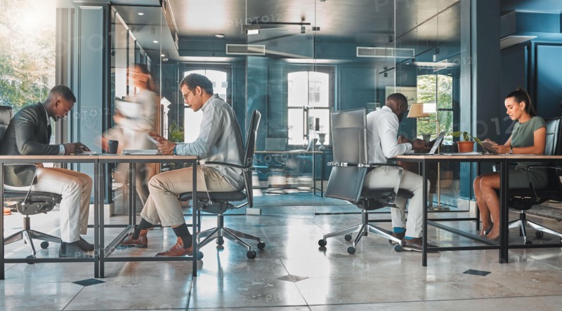 Coworking space, office and sharing desk in corporate workplace. Diversity, efficiency and modern working environment for inclusive company. Start up and motion blur of fast and busy employees