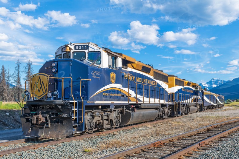 Rocky Mountaineer train locomotive and Edith Cavell mountain, Jasper national park, Canada.
