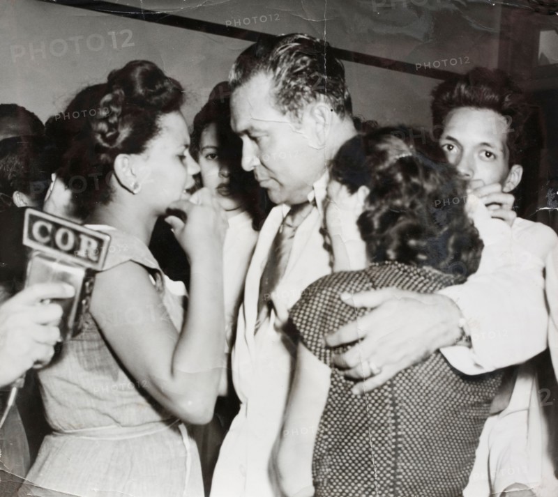 Cuban president Fulgencio Batista offering words of comfort to women whose husbands had been killed on 26th July 1953