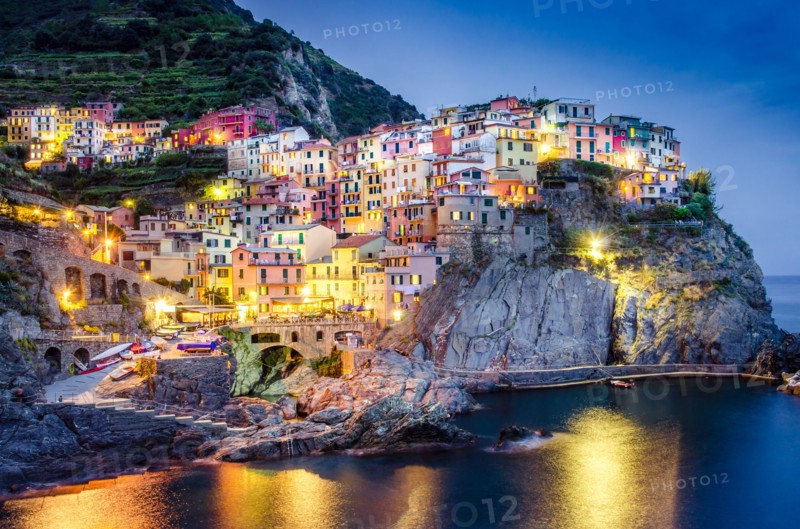 Scenic night view of colorful village Manarola in Cinque Terre, Italy