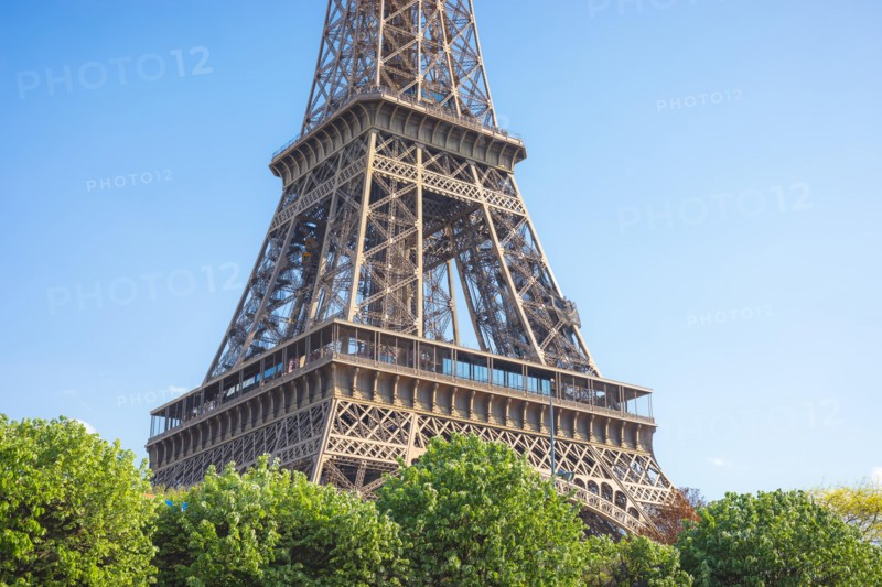Close up of a part of Eiffel tower against a bright blue sky , Paris , France