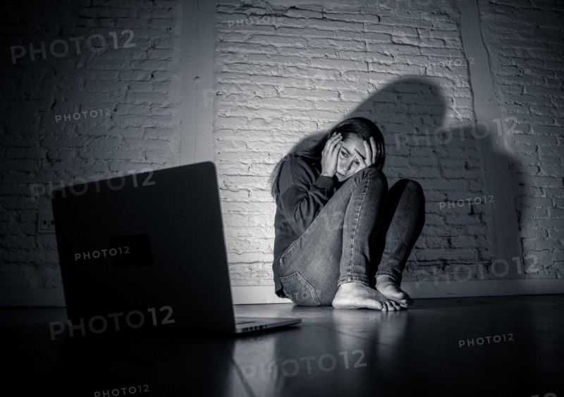 Woman suffering Internet cyber bullying