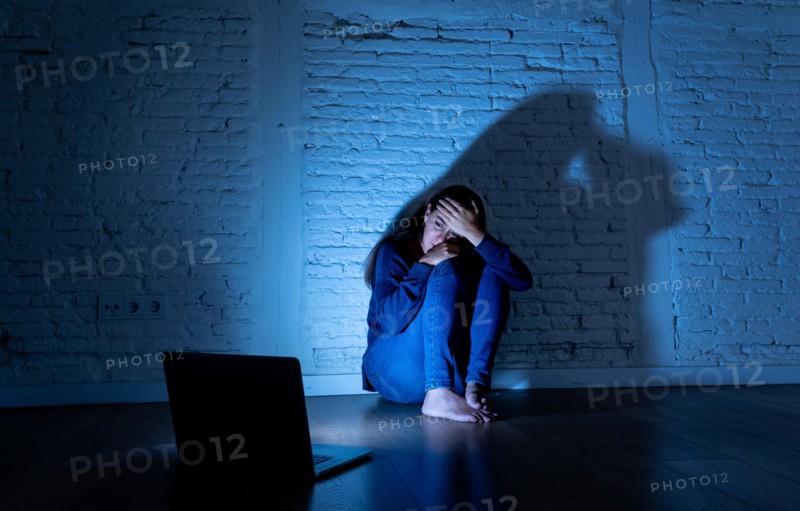 Woman suffering Internet cyber bullying