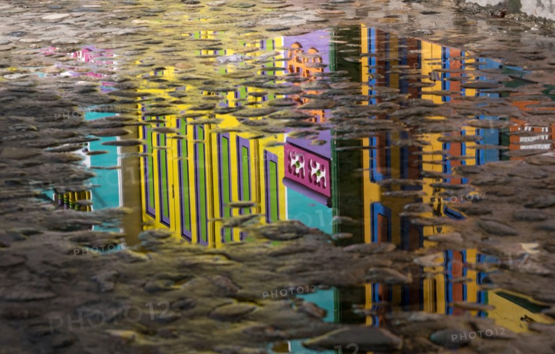 Cobblestone with reflection of colorful City of Guatape, Colombia
