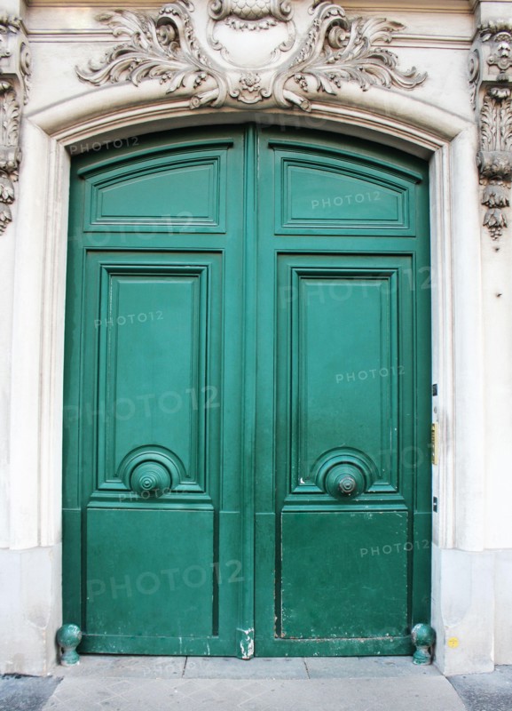 Old fashioned front door entrance, white facade and green door, Paris, France