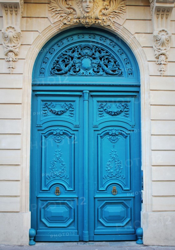 Old fashioned front door entrance, white facade and blue door, Paris, France