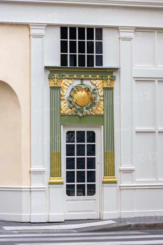 Paris, an ancient door, beautiful decorated facade in the Opera district