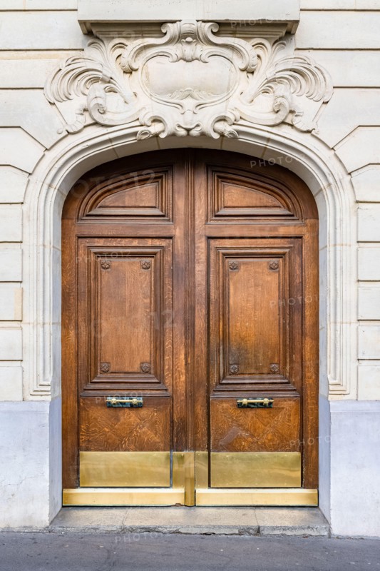 Paris, an ancient wooden door, beautiful facade in the 11e arrondissement