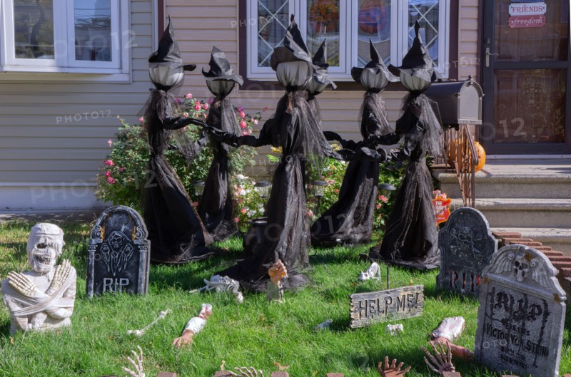 A house in Bayside, decorated for Halloween with dancing witches, skeletons, sculls & tombstones. In Queens, New York City,