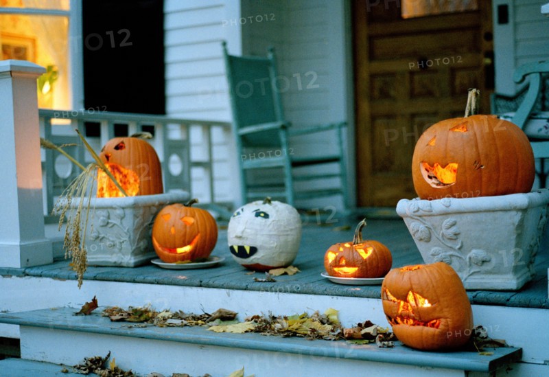 Halloween pumpkins glowing on a porch in Sharon, Connecticut, New England, USA.