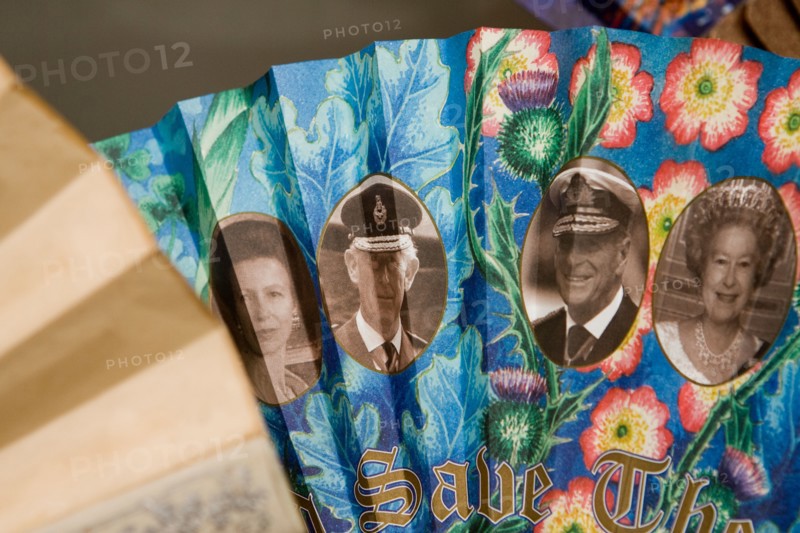 A fan depicting the British Royal Family with the slogan GOD SAVE THE QUEEN printed on it on display at the Fan Museum Greenwich