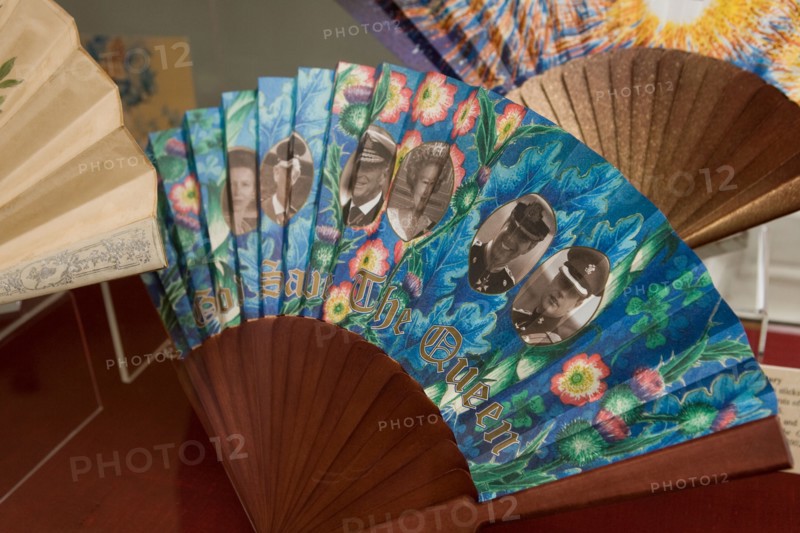 A fan depicting the British Royal Family with the slogan GOD SAVE THE QUEEN printed on it on display at the Fan Museum Greenwich