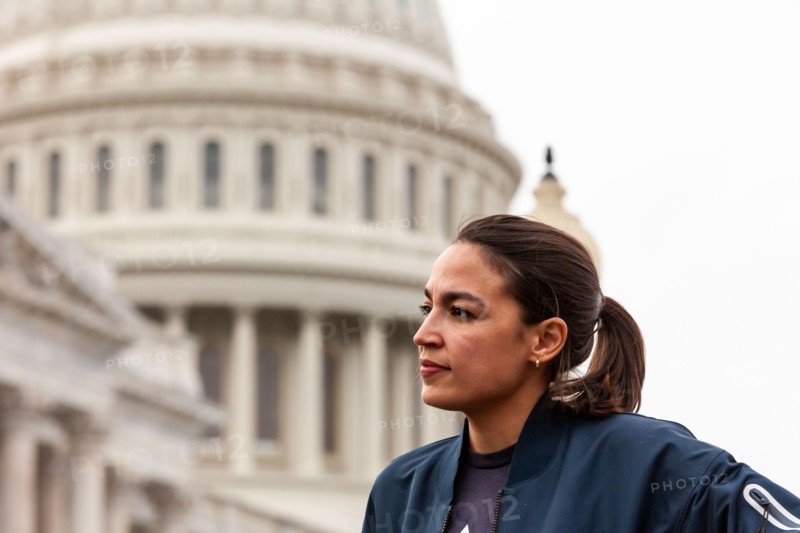 Congresswoman Alexandria Ocasio-Cortez (D-NY) listens as Congresswoman Cori Bush answers questions about her role in extending the pandemic eviction moratorium at a press conference announcing the new 60-day ban on evictions.