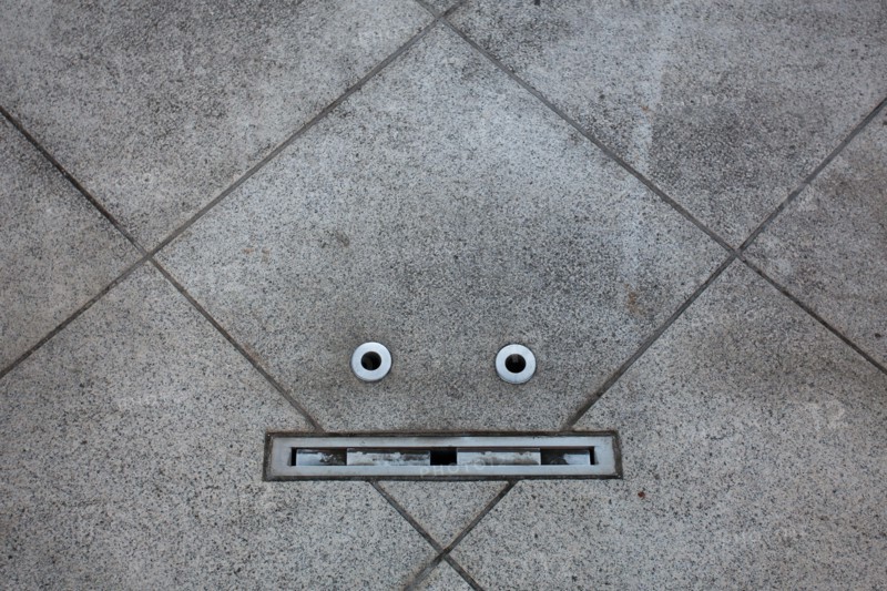 Details in a floor resemble a face in an example of pareidolia. Tokyo, Japan.