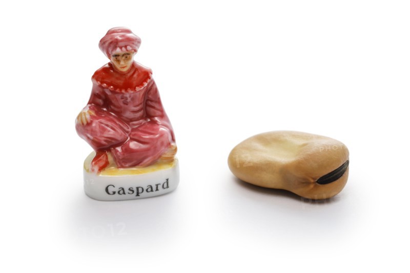 small porcelain doll and broad bean to hide in Roscón de Reyes (Spanish King’s cake).