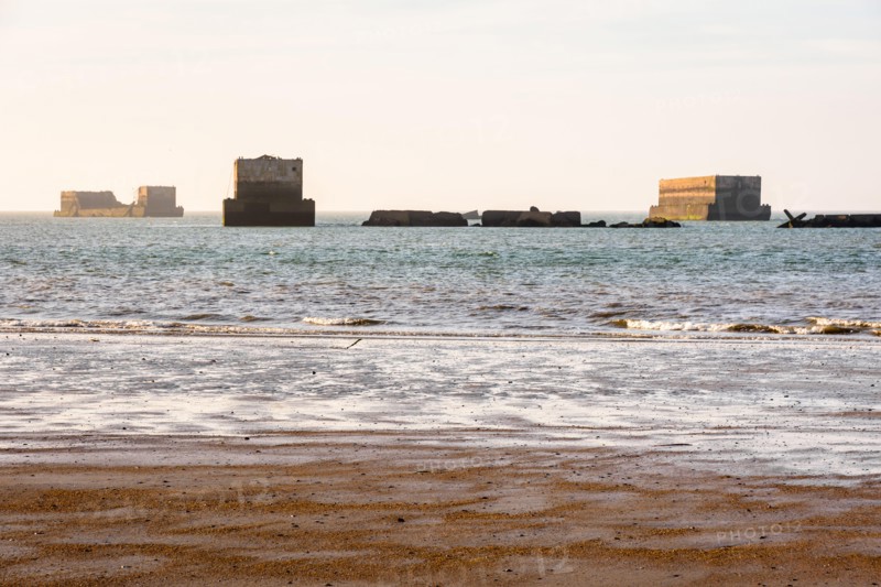 Remains of Phoenix caissons used to build the artificial Mulberry harbour on Gold Beach in Arromanches, France, after the Normandy landings in WWII.