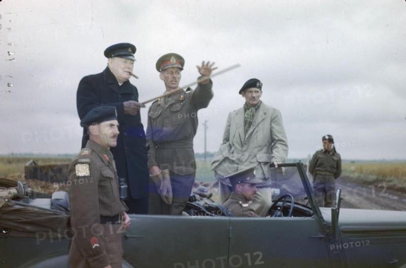 The Visit of the Prime Minister, Winston Churchill To Caen, Normandy, 22 July 1944 The Commander of the British 2nd Army, Lieutenant General Sir Miles Dempsey, pointing out a section of the front to the Prime Minister, the Rt Hon Winston Churchill, MP. Also in the picture are the Commander of the 2nd Canadian Corps, Lieutenant General G G Simonds (left) and the Commander of the 21st Army Group General Sir Bernard Montgomery (right).