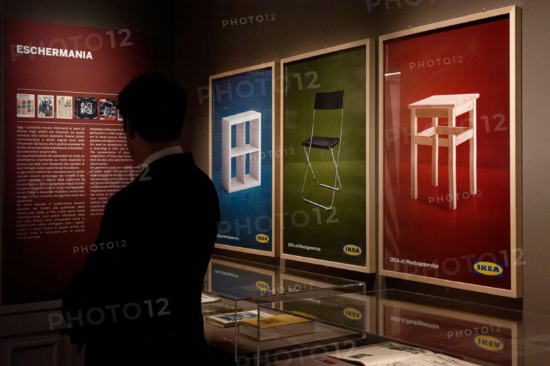 A visitor looks on artworks by Dutch engraver and graphic designer Maurits Cornelis Escher on display at the 'Escher' exhibition